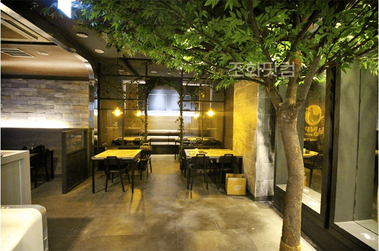 서울 더냄비 강남역점 — 어두운 톤과 대비되는 나무와 넝쿨