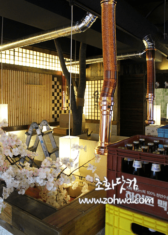 서울 육회공작소 노원점 — 목재 기둥 사이 벚꽃